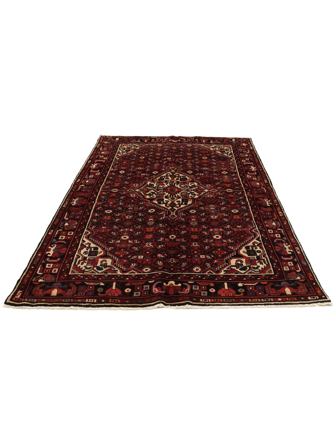 Hand-knotted Hosseinabad rug with a dark-red field and traditional geometric motifs