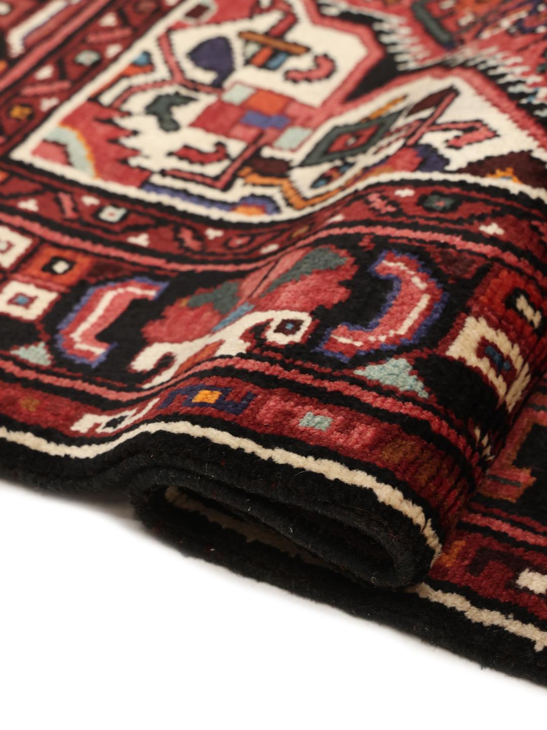 Hand-knotted Hosseinabad rug with a dark-red field and traditional geometric motifs
