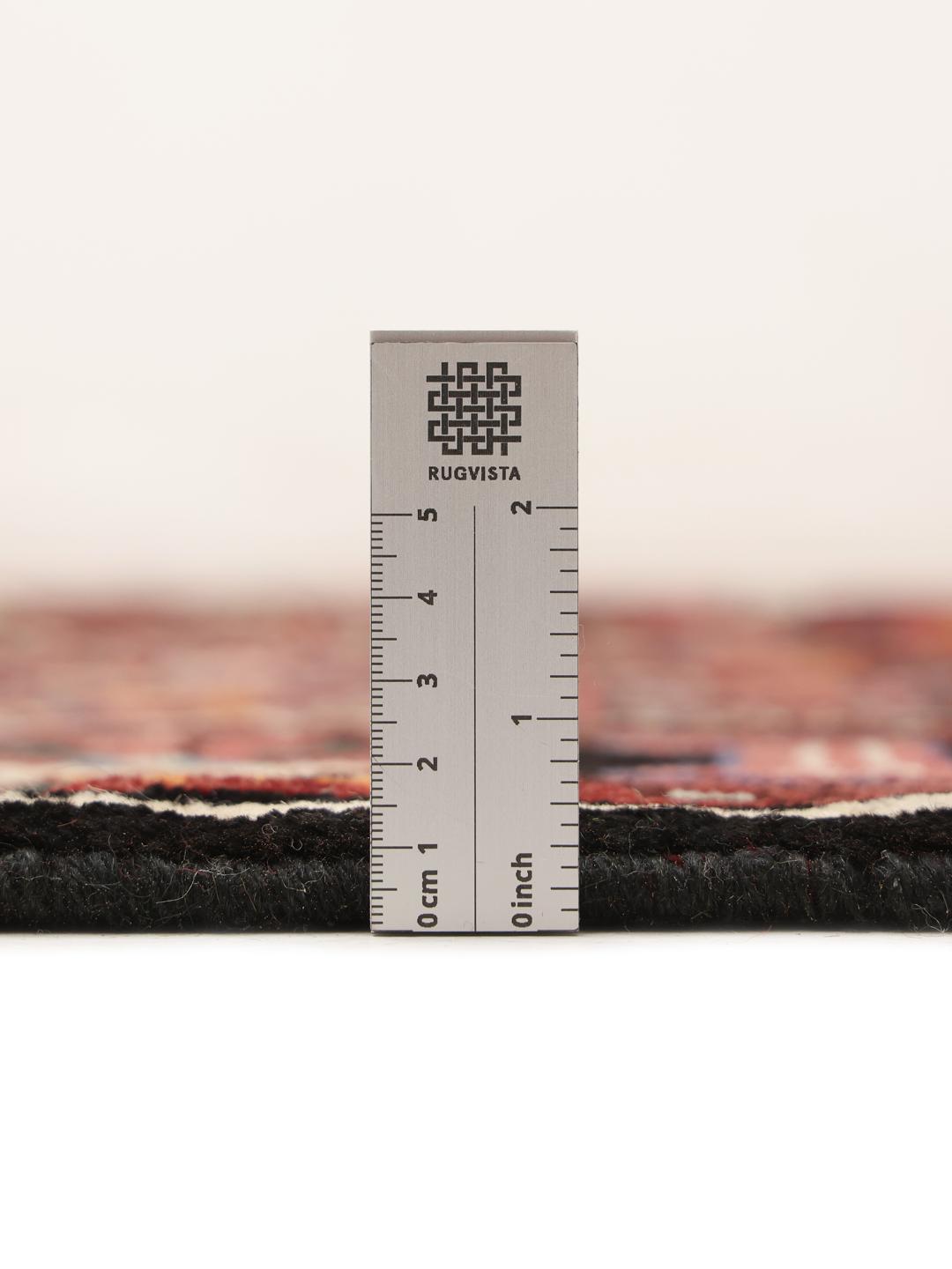 Hand-knotted Hosseinabad rug with a dark-red field and traditional geometric motifs