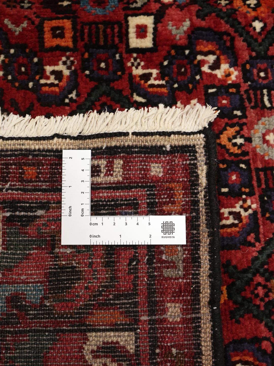 Hand-knotted Hosseinabad rug with a dark-red field and traditional geometric motifs