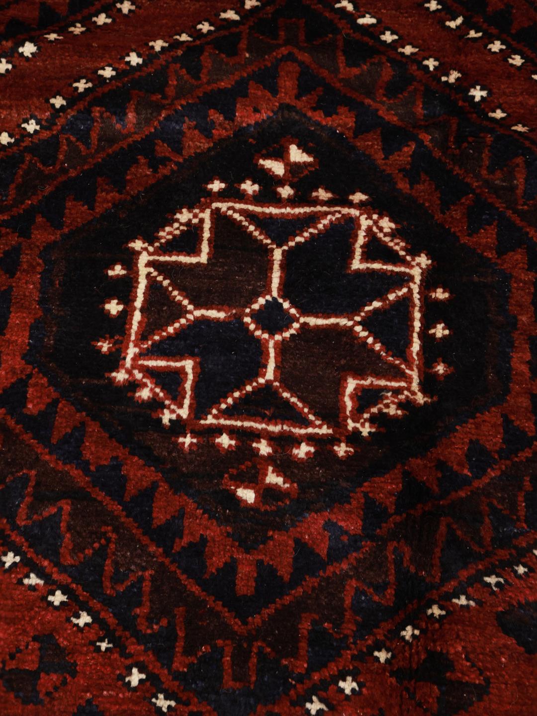 Hand-knotted Lori rug from the Middle East featuring a dark-red geometric pattern