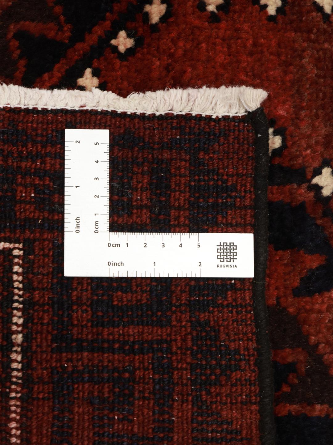 Hand-knotted Lori rug from the Middle East featuring a dark-red geometric pattern