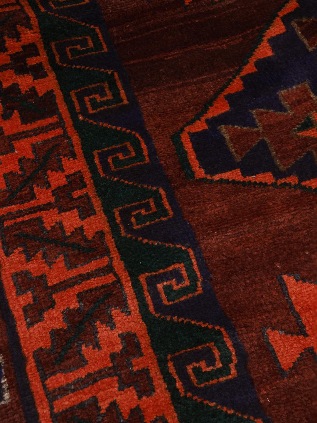 Hand-knotted Lori rug from the Middle East in dark-red and dark-blue tones.