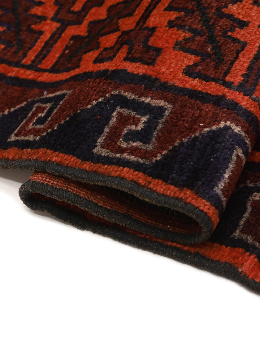 Hand-knotted Lori rug from the Middle East in dark-red and dark-blue tones.