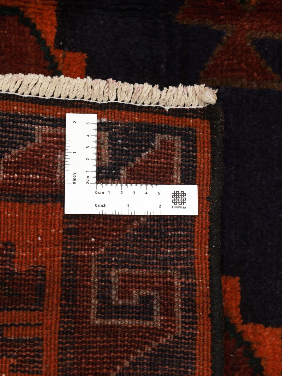 Hand-knotted Lori rug from the Middle East in dark-red and dark-blue tones.