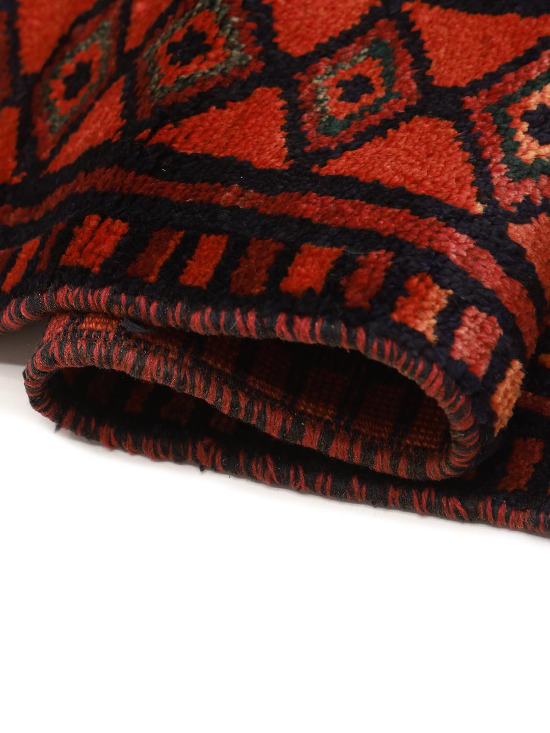 A hand-knotted Lori rug from the Middle East featuring geometric patterns in dark red and black.