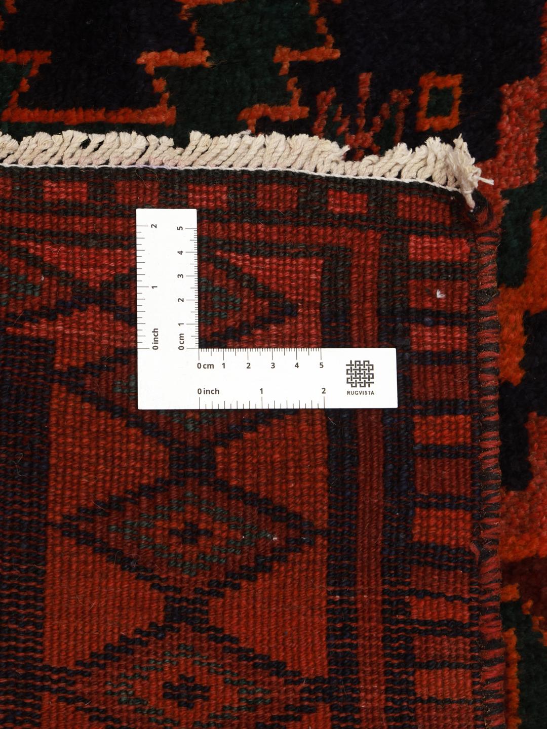 A hand-knotted Lori rug from the Middle East featuring geometric patterns in dark red and black.
