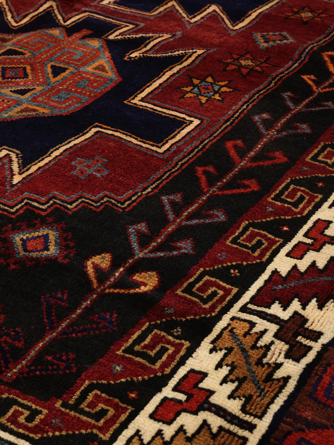 Hand-knotted Lori rug from the Middle East featuring a dark-red and dark-blue geometric pattern