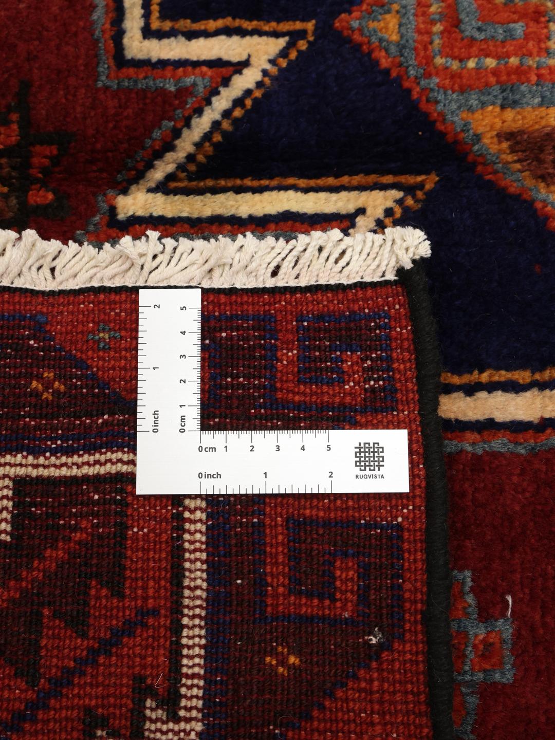 Hand-knotted Lori rug from the Middle East featuring a dark-red and dark-blue geometric pattern