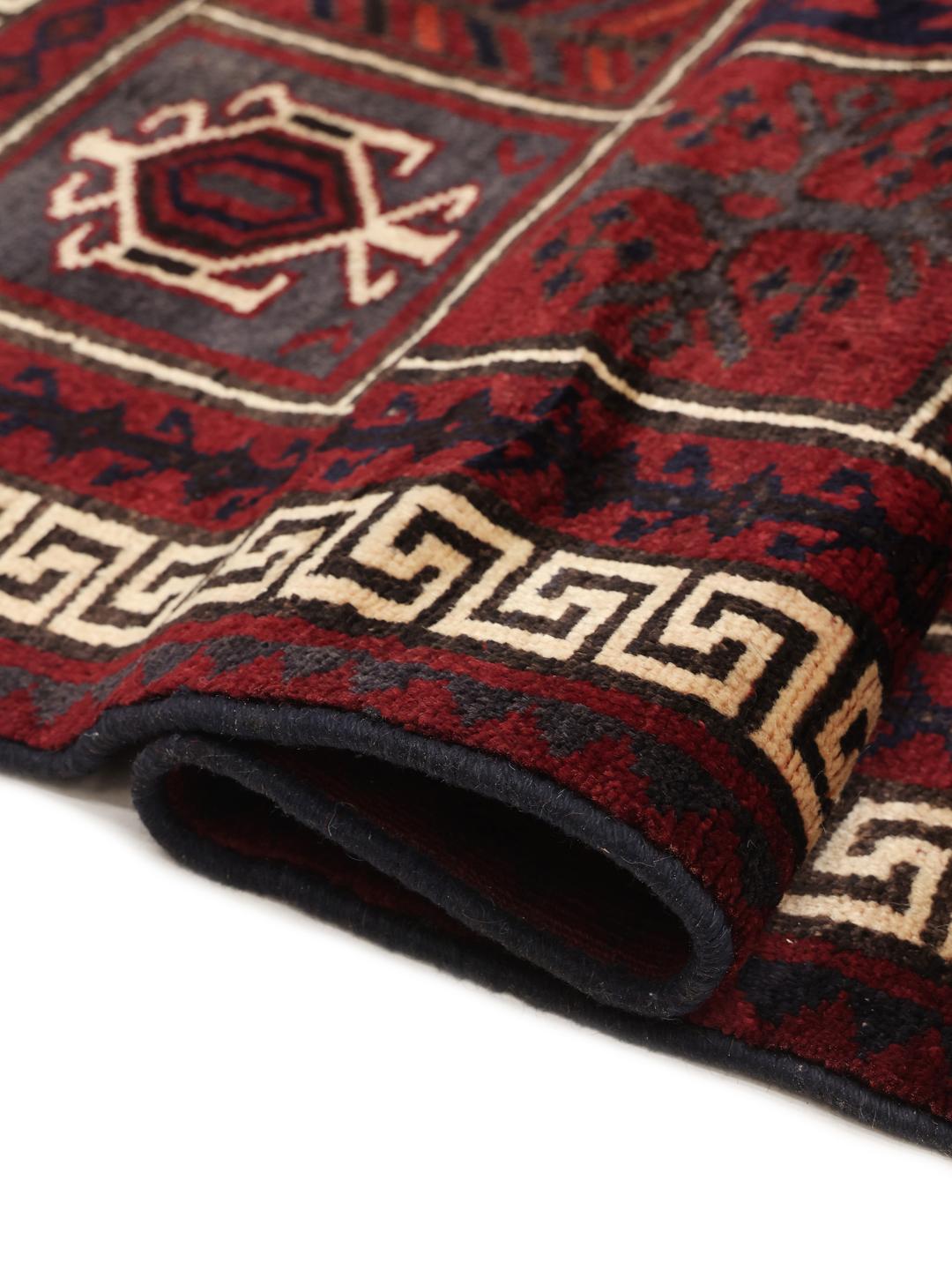 Hand-knotted Lori rug from the Middle East in dark-red and black with geometric patterns