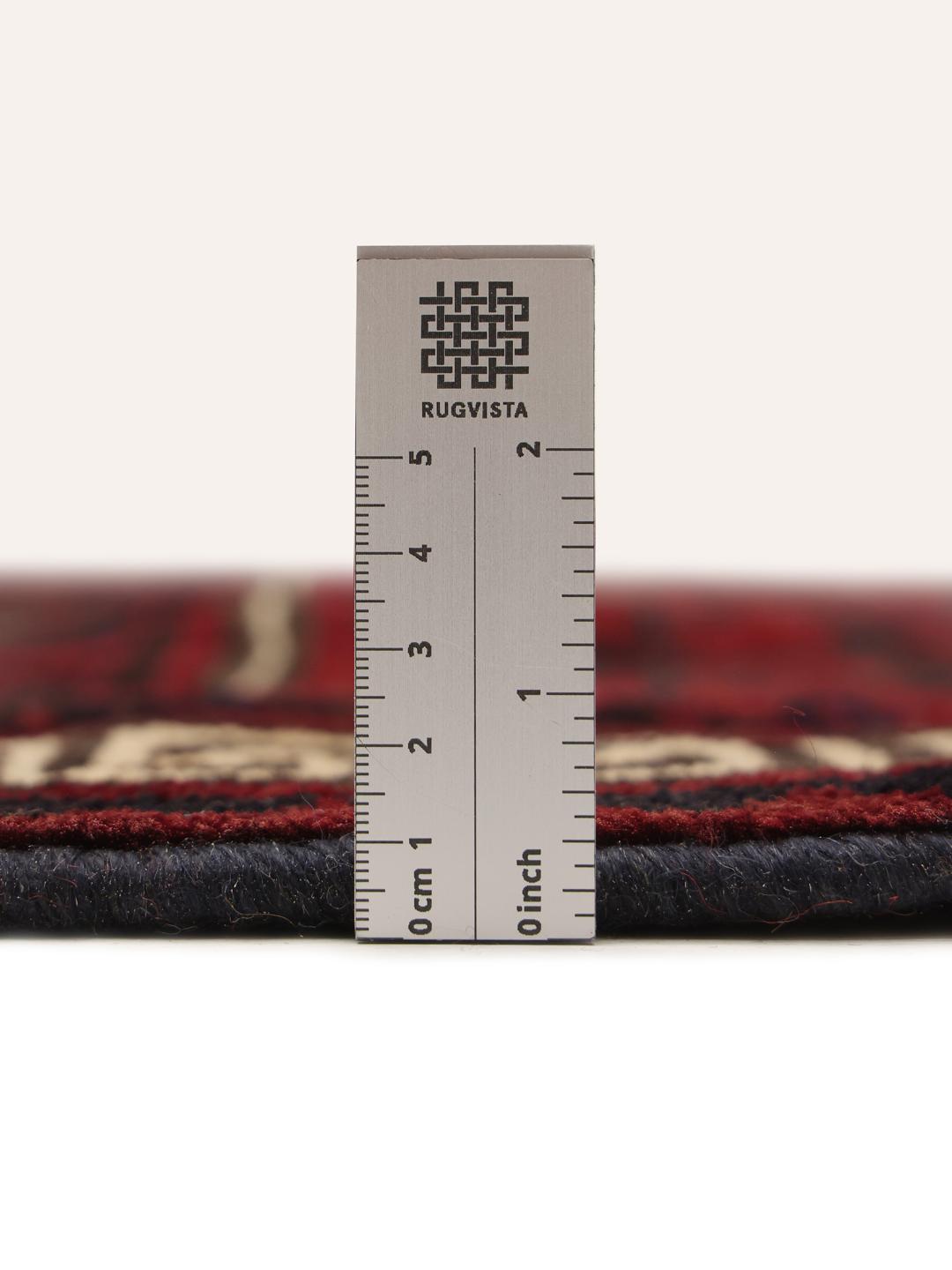 Hand-knotted Lori rug from the Middle East in dark-red and black with geometric patterns