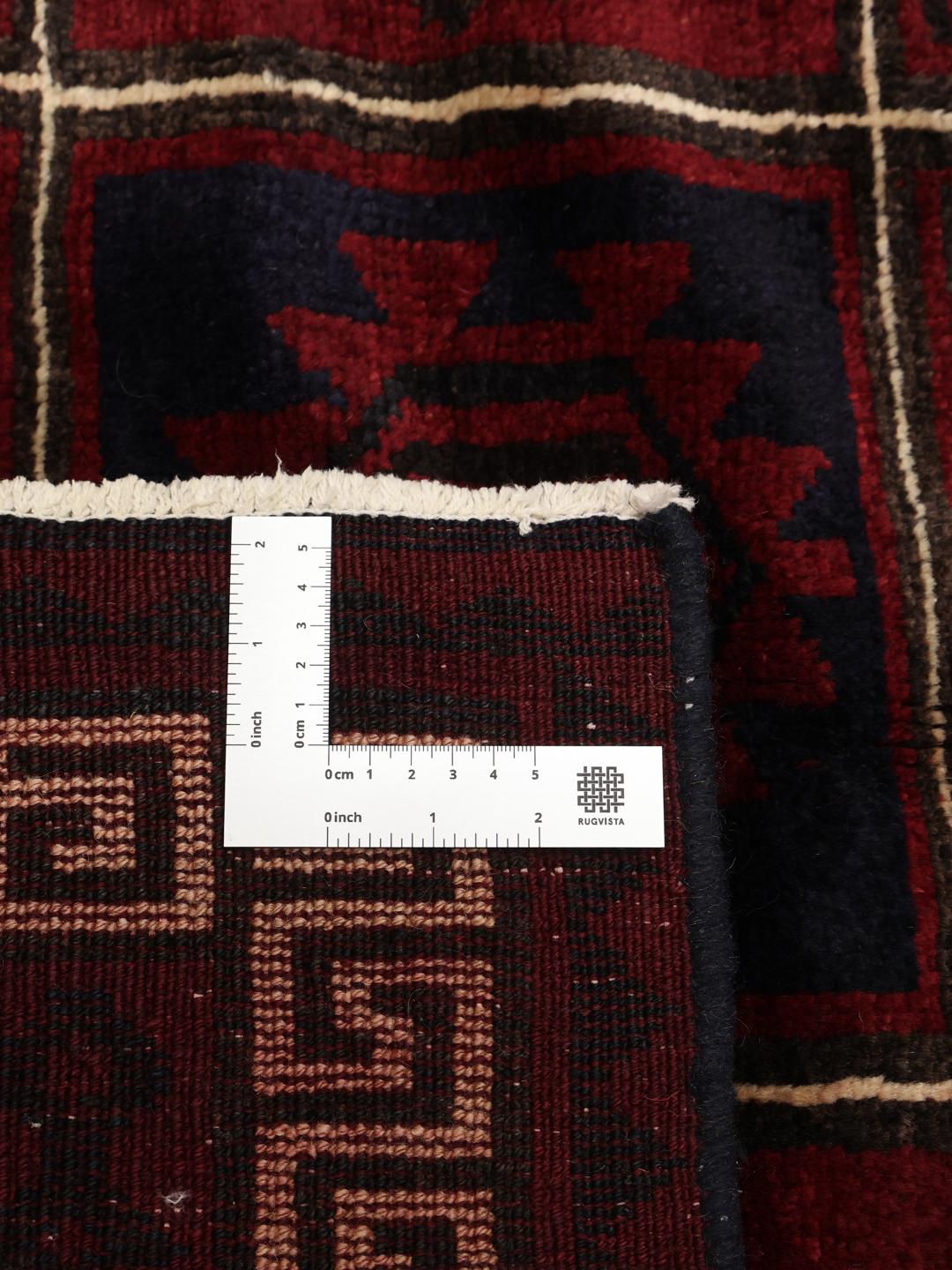 Hand-knotted Lori rug from the Middle East in dark-red and black with geometric patterns