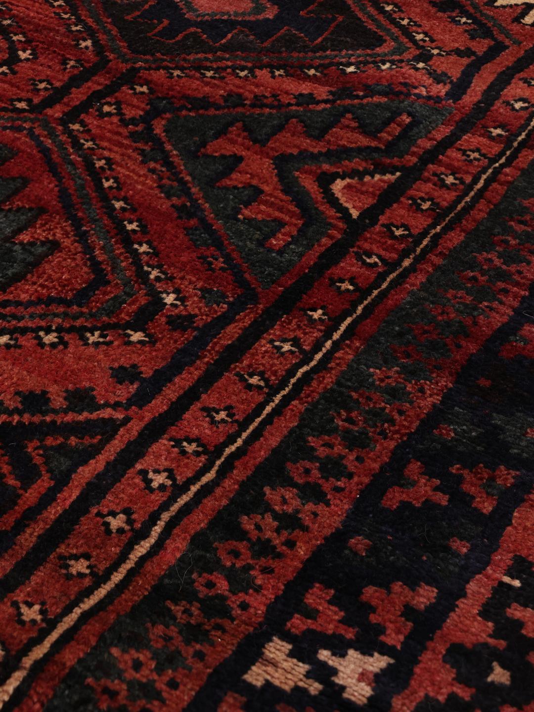 Hand-knotted Lori rug from the Middle East in deep red and blue tones