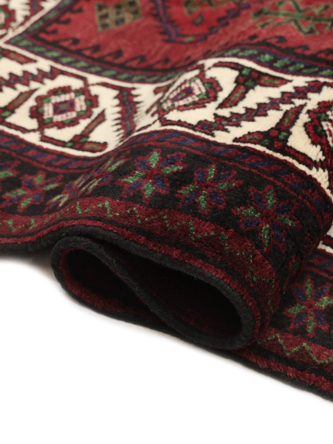 Handmade Lori rug from the Middle East with a deep red field and geometric motifs
