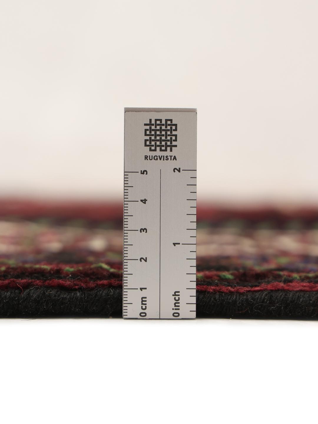 Handmade Lori rug from the Middle East with a deep red field and geometric motifs