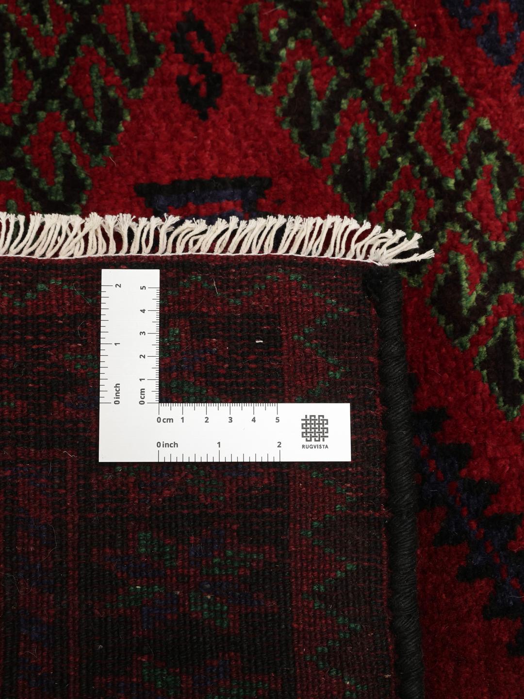 Handmade Lori rug from the Middle East with a deep red field and geometric motifs