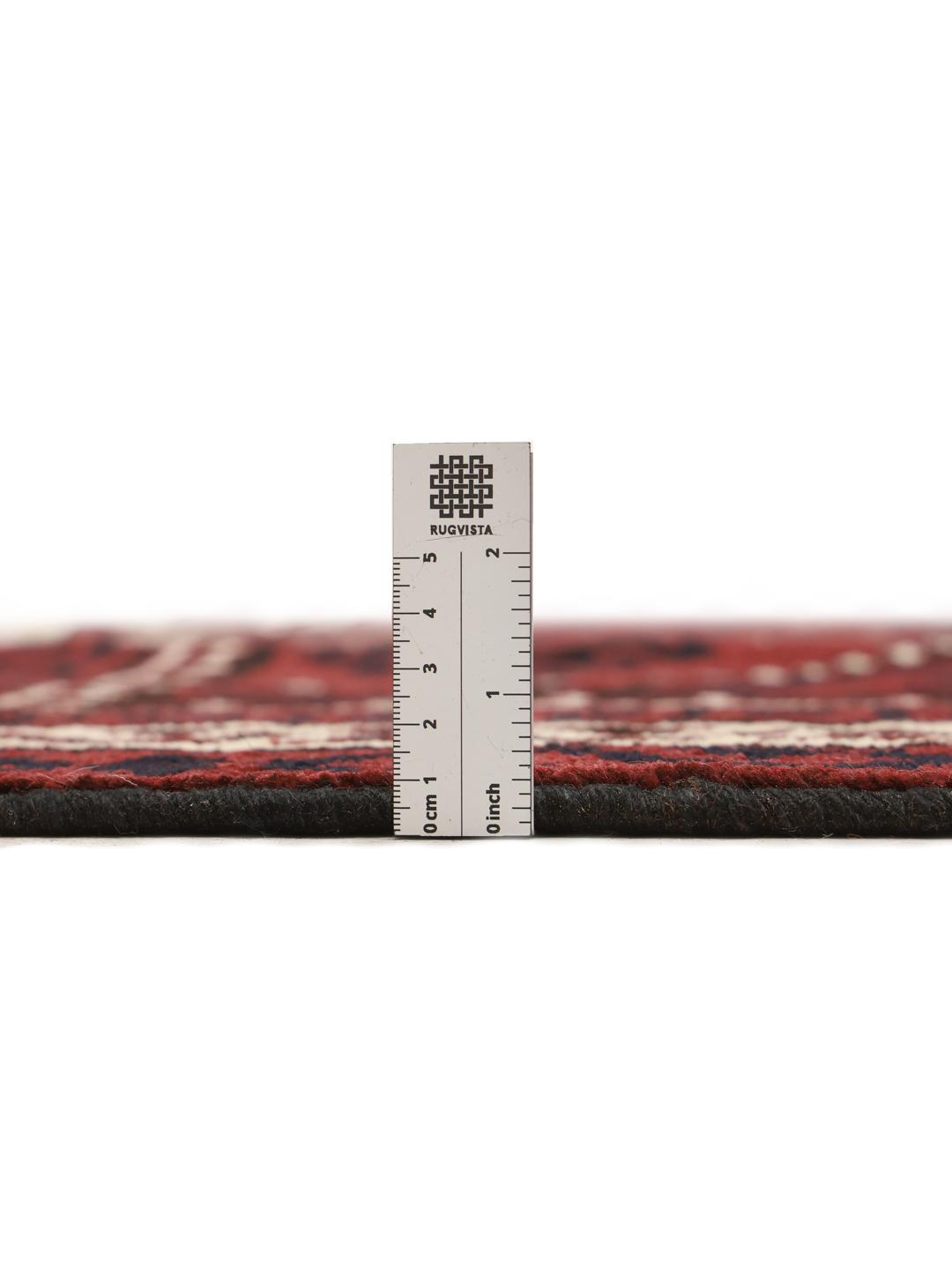 A hand-knotted Lori rug from the Middle East in dark-red with geometric patterns.