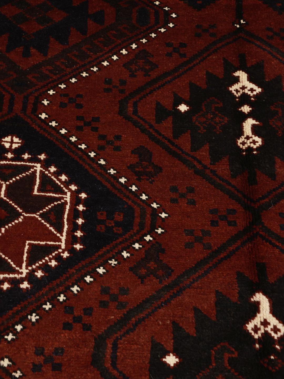 Håndknyttet Lori-tæppe fra Mellemøsten i mørkerøde og sorte toner.