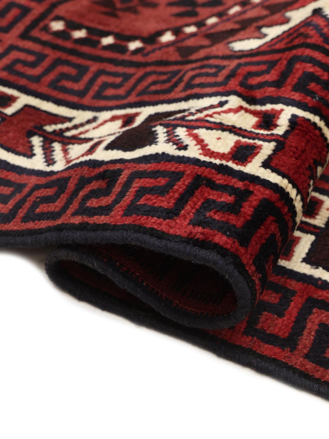 Hand-knotted Lori rug from the Middle East with a deep red and geometric tribal pattern