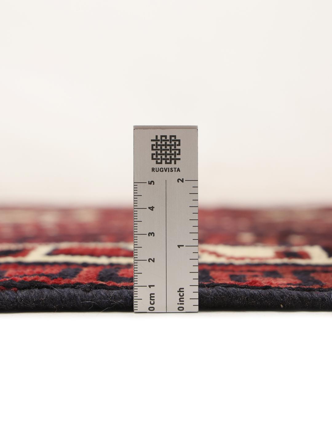 Hand-knotted Lori rug from the Middle East with a deep red and geometric tribal pattern