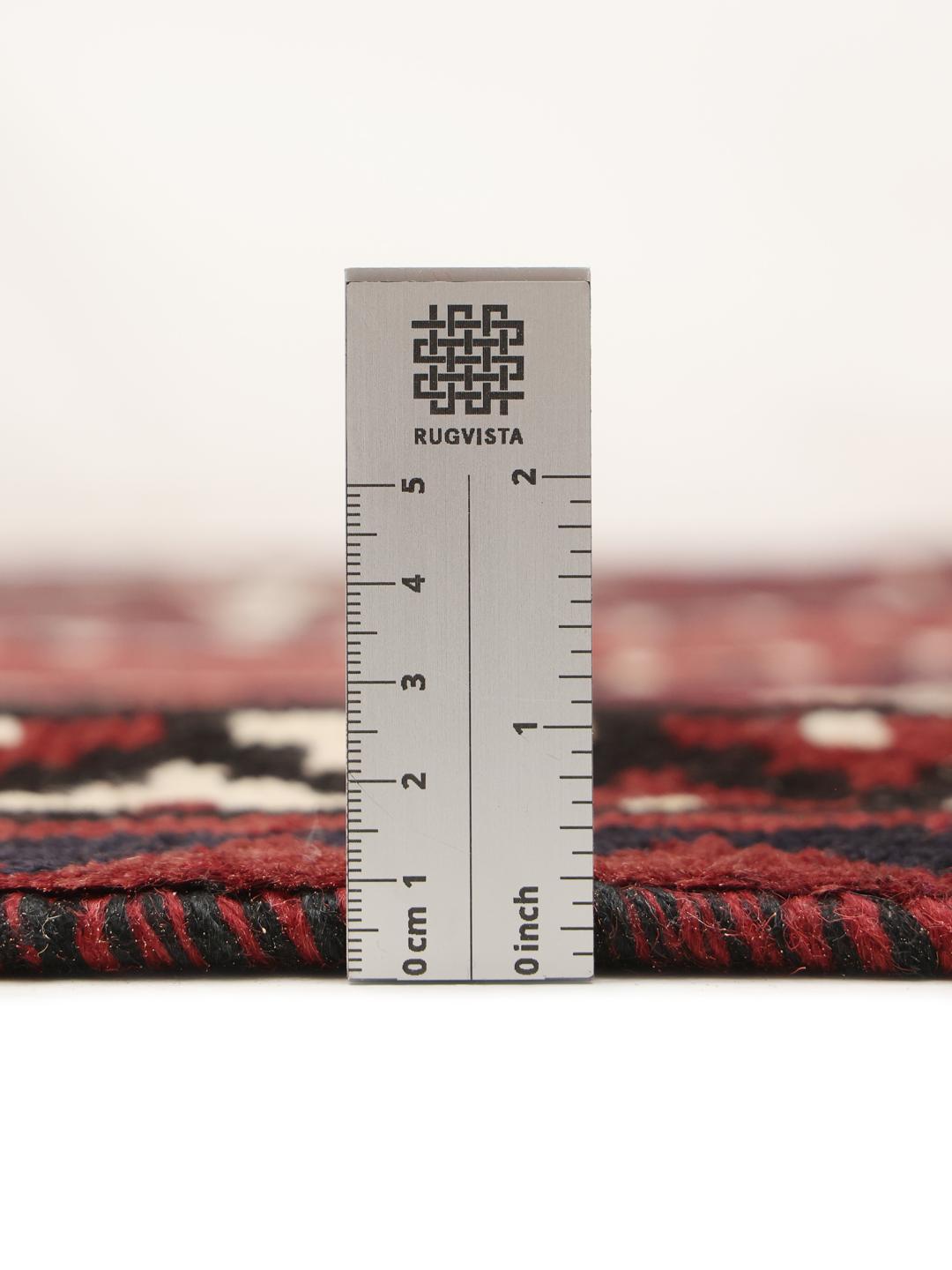 A unique hand-knotted Lori rug from the Middle East in dark-red with geometric patterns.