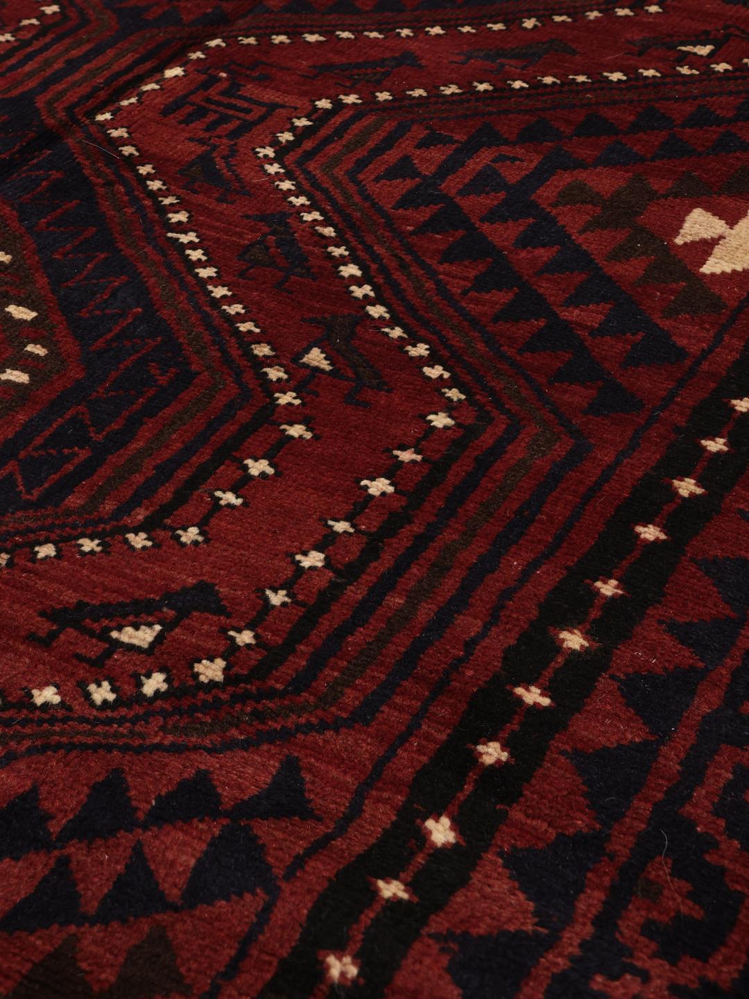 Hand-knotted Lori rug from the Middle East in dark-red and dark-blue tones.