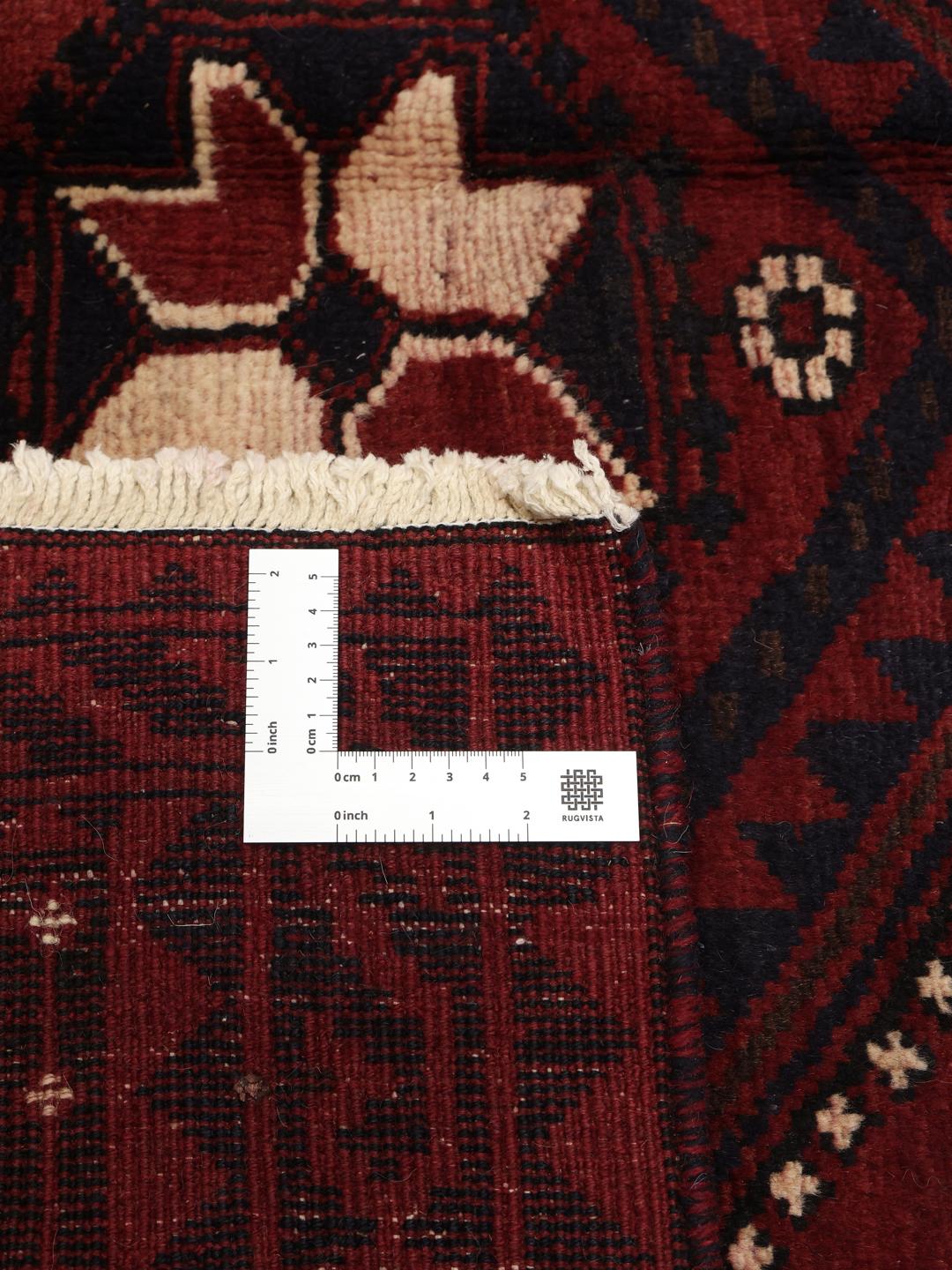 Hand-knotted Lori rug from the Middle East in dark-red and dark-blue tones.