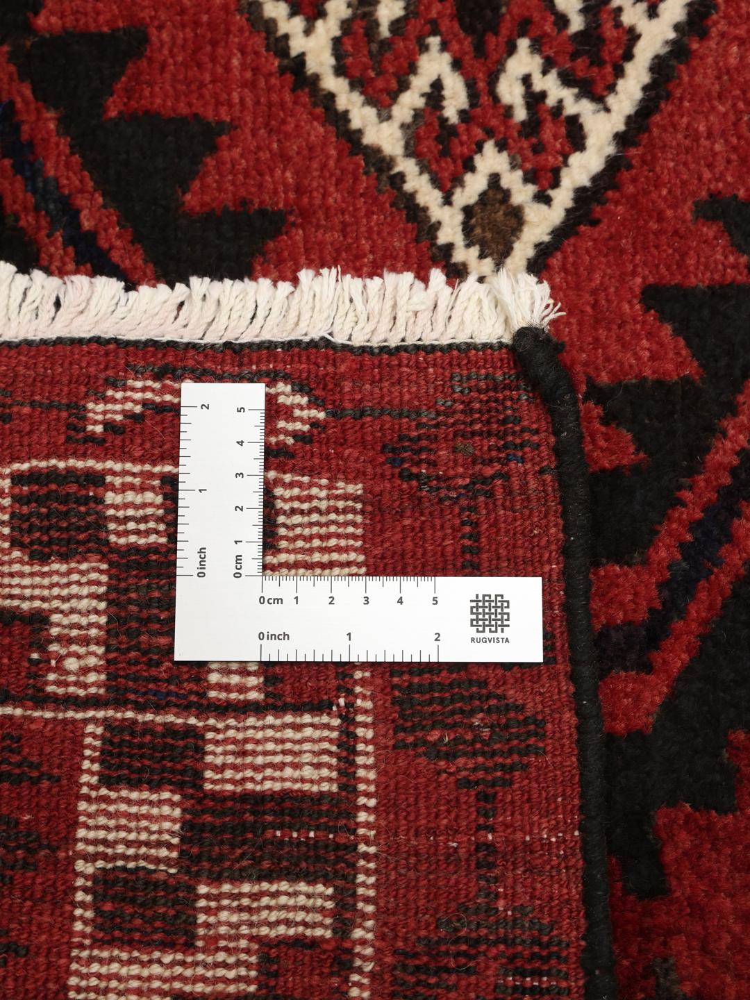 Hand-knotted Lori rug from the Middle East in dark-red and black tones.