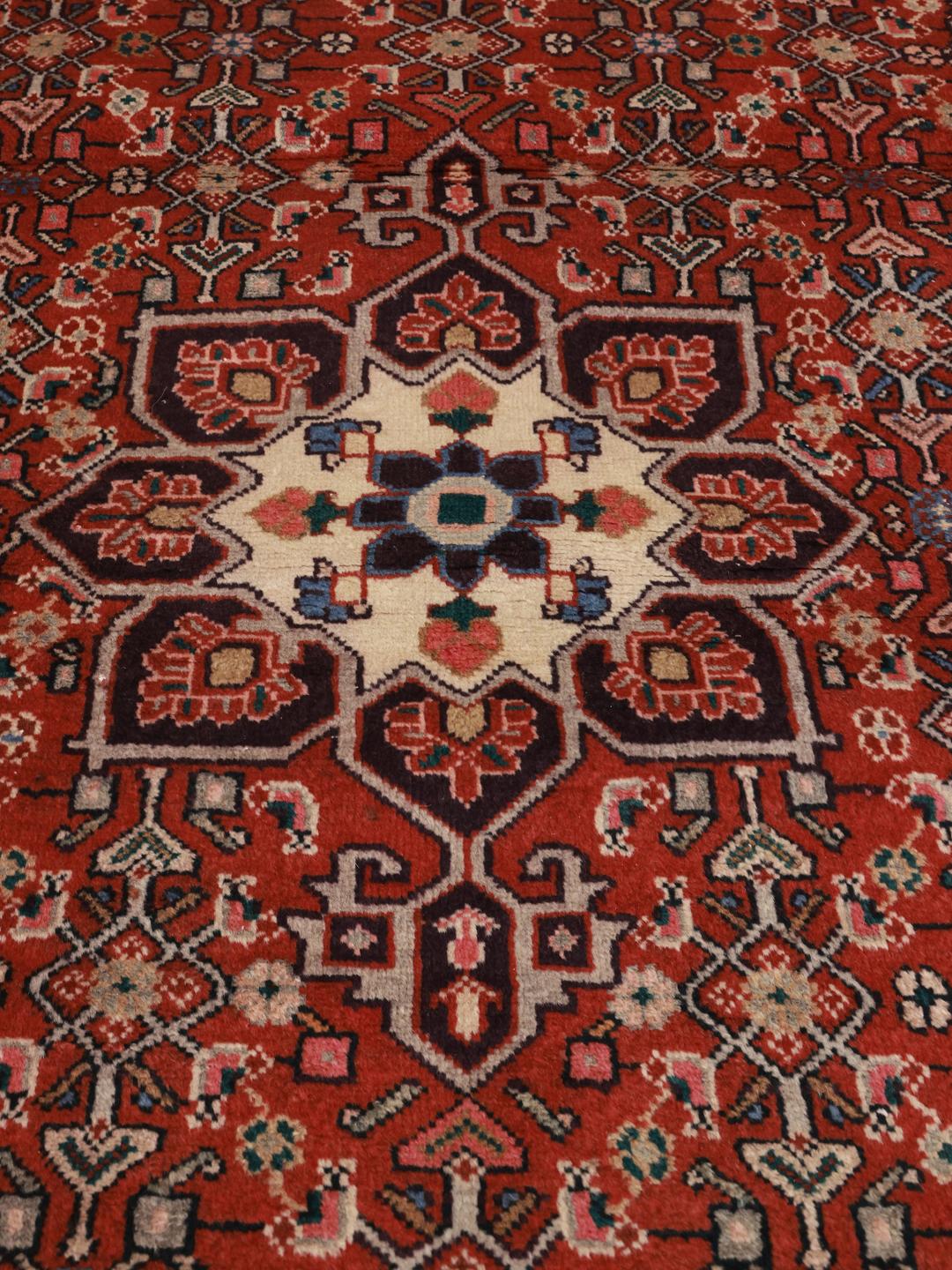 Hand-knotted Hamadan rug from the Middle East in vibrant red with traditional medallion patterns.