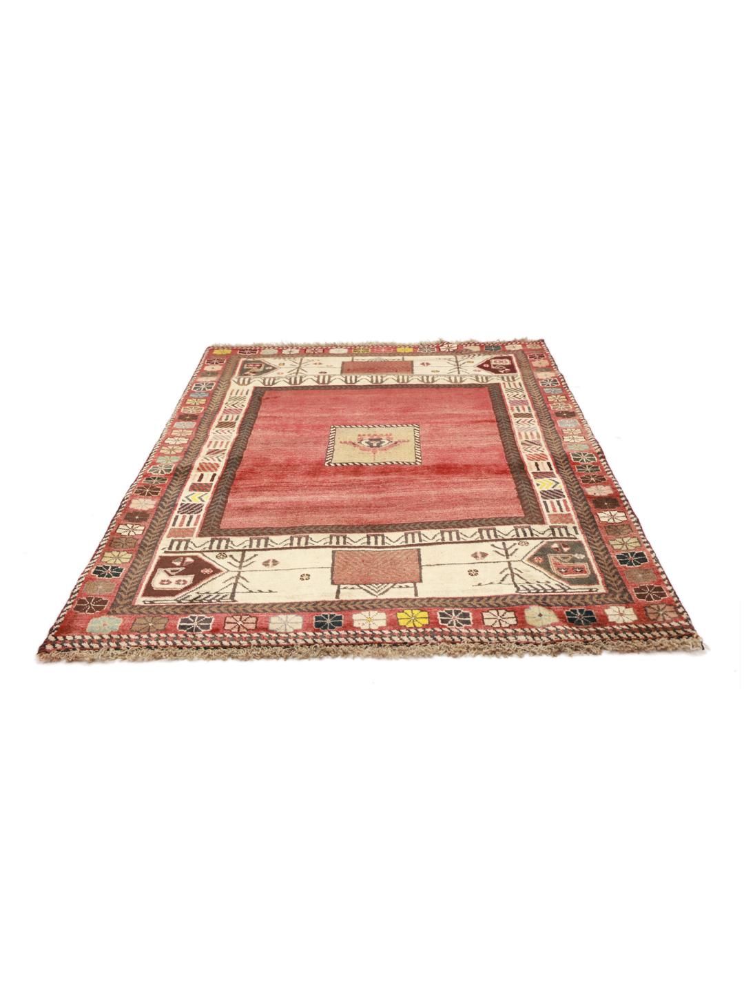 A hand-knotted Shiraz rug from the Middle East featuring a vibrant red field and tribal motifs.