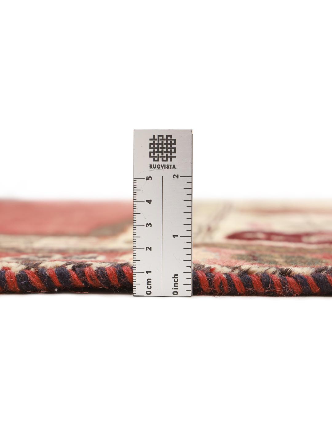 A hand-knotted Shiraz rug from the Middle East featuring a vibrant red field and tribal motifs.