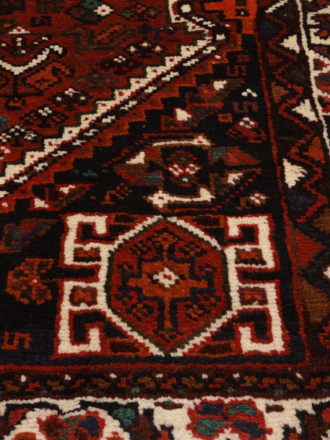 Hand-knotted red Shiraz rug with geometric tribal patterns from the Middle East