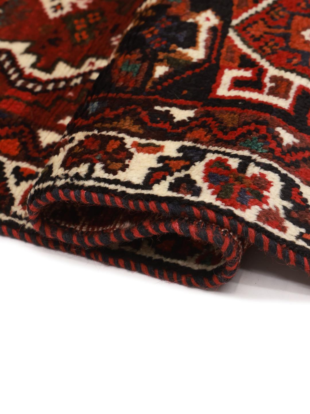 Hand-knotted red Shiraz rug with geometric tribal patterns from the Middle East
