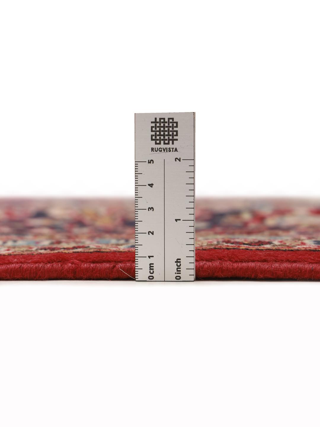 A hand-knotted red Keshan rug from the Middle East with a floral medallion pattern.