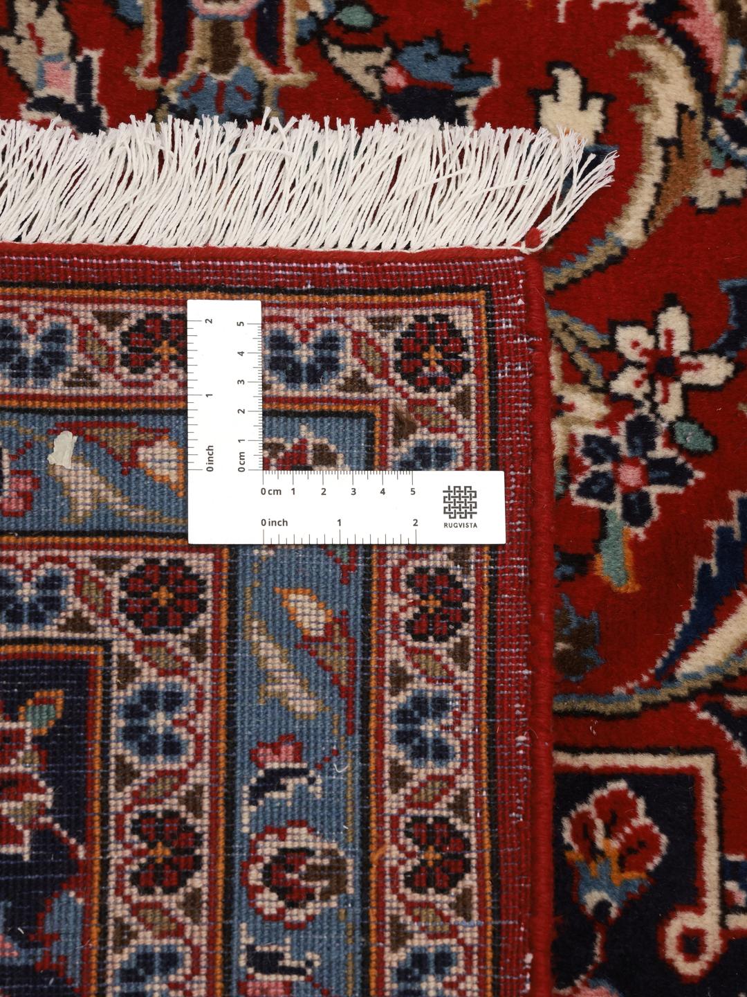 A hand-knotted red Keshan rug from the Middle East with a floral medallion pattern.