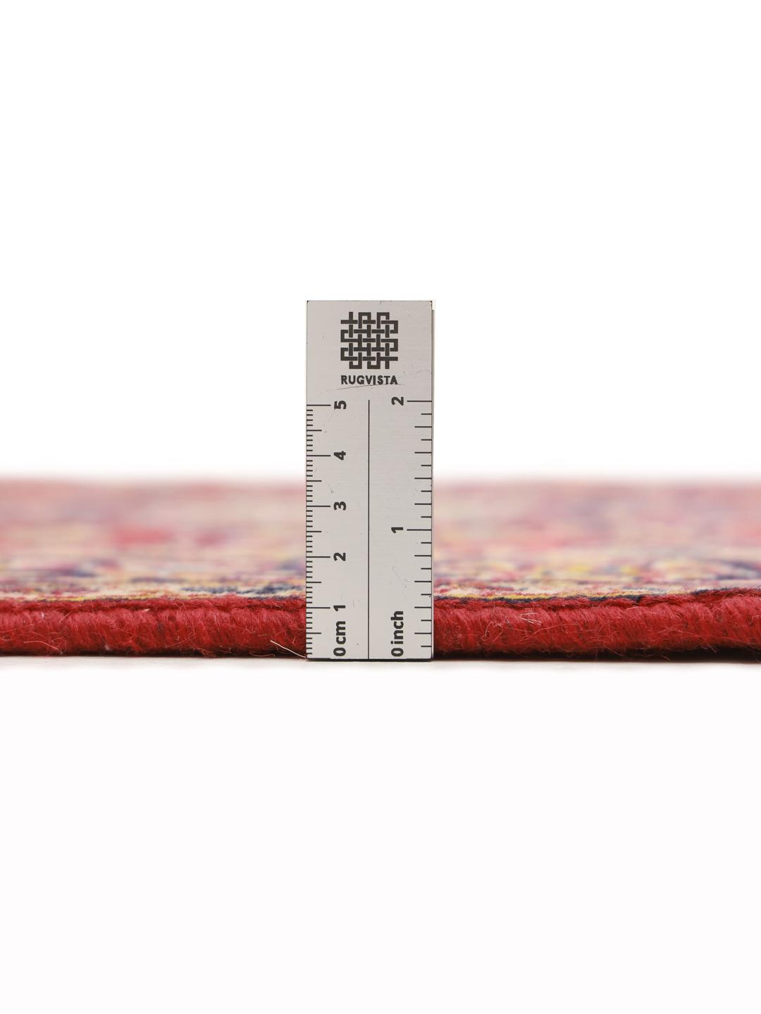 A hand-knotted Middle Eastern Keshan runner in red with floral medallion patterns.