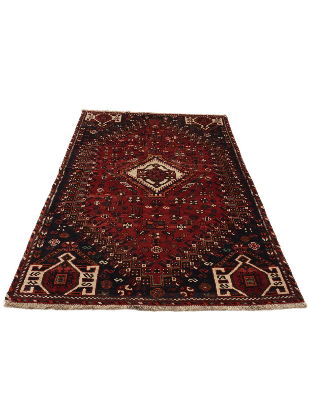 A hand-knotted Ghashghai rug from the Middle East featuring a vibrant red and black colour scheme.