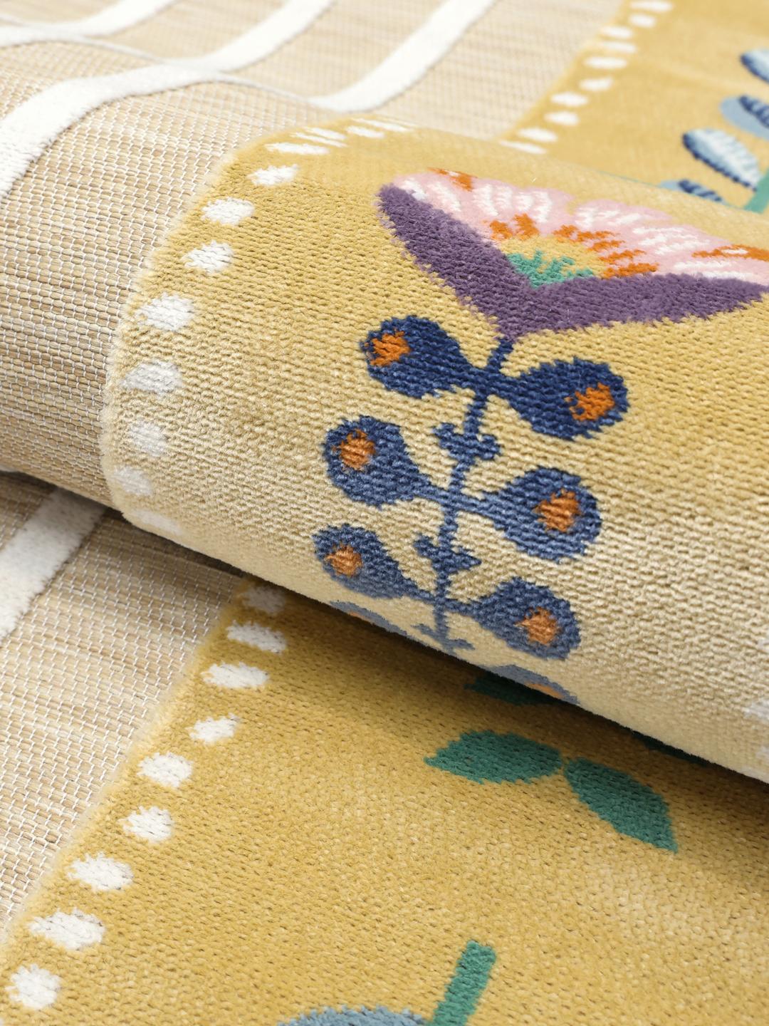 Gult rundt tæppe med stribet midte og blomsterrand