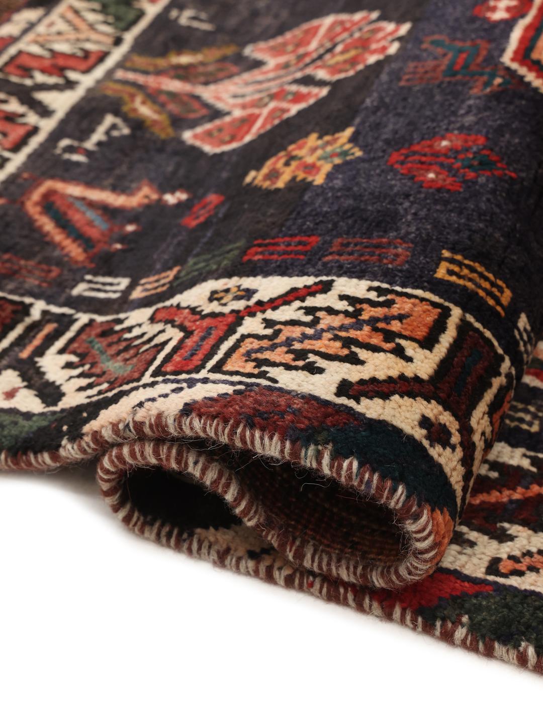 Hand-knotted Shiraz rug from the Middle East in deep red and dark blue tones
