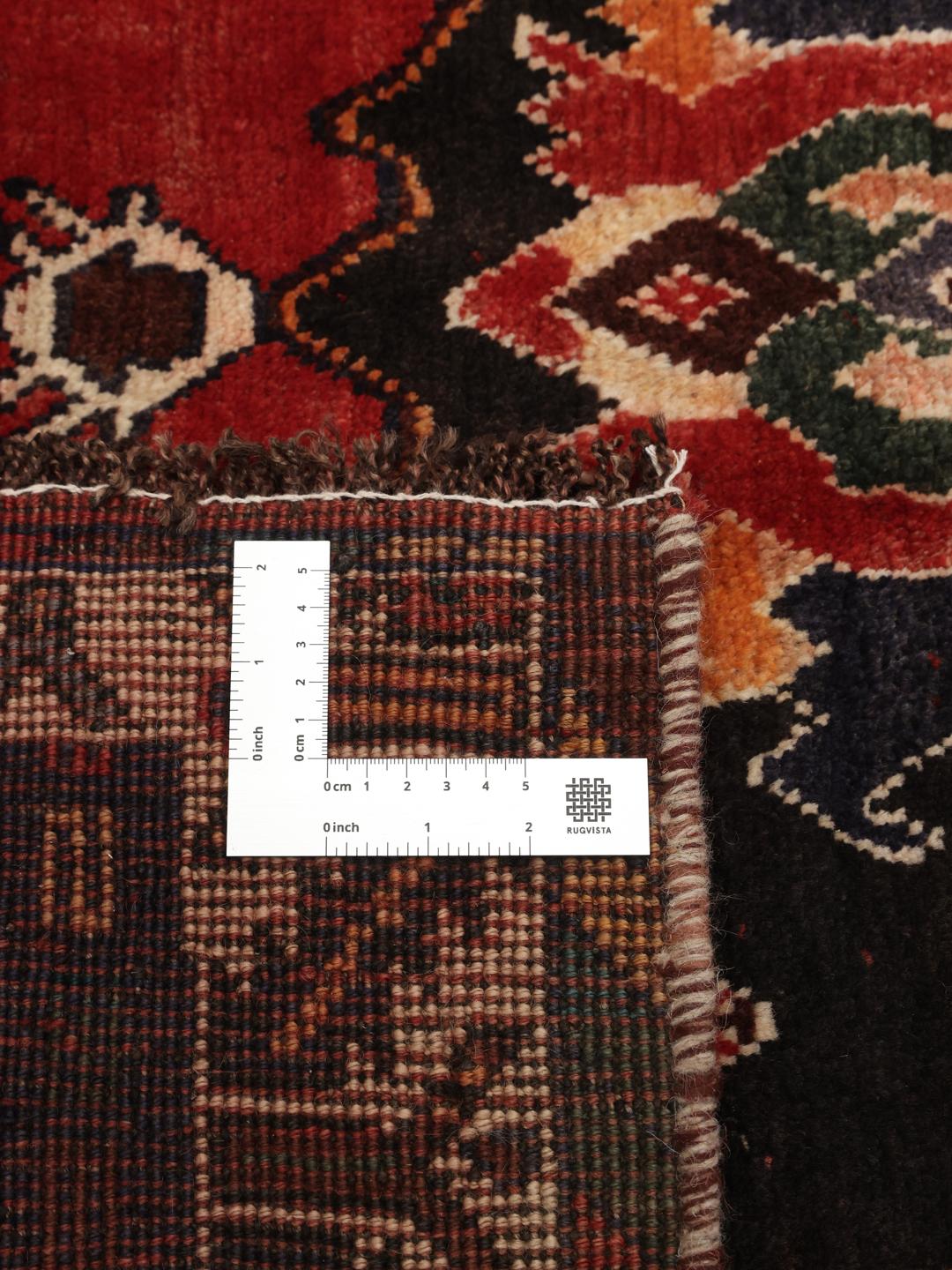Hand-knotted Shiraz rug from the Middle East in deep red and dark blue tones