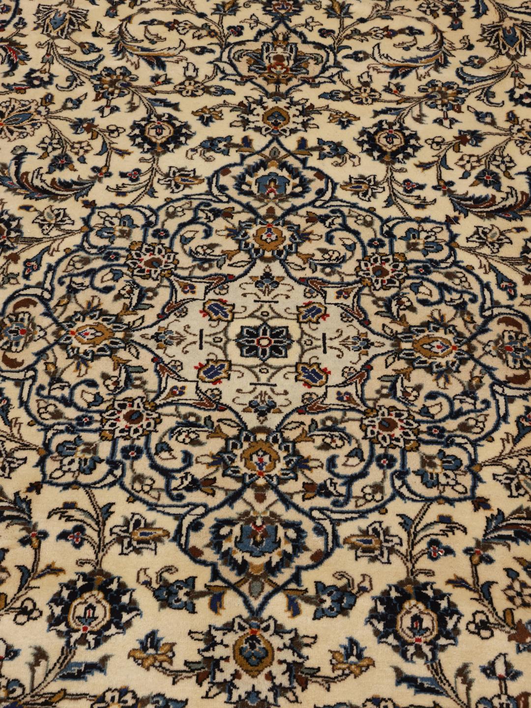 Hand-knotted Keshan rug with floral patterns in beige and blue tones