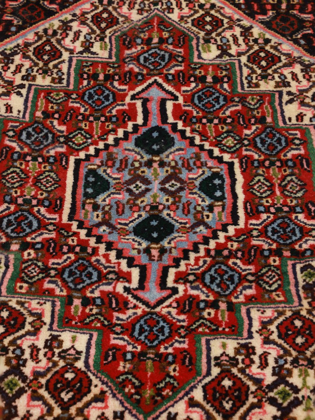 Hand-knotted Senneh rug from the Middle East featuring a vibrant multicolor geometric pattern