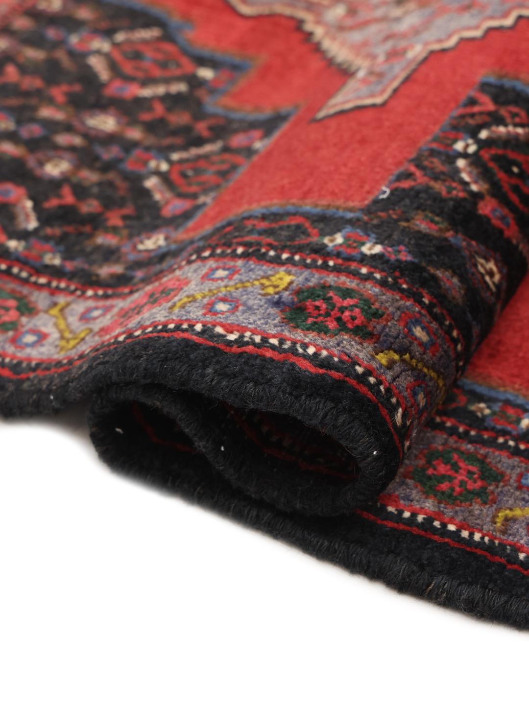 Hand-knotted Senneh rug from the Middle East in red and black