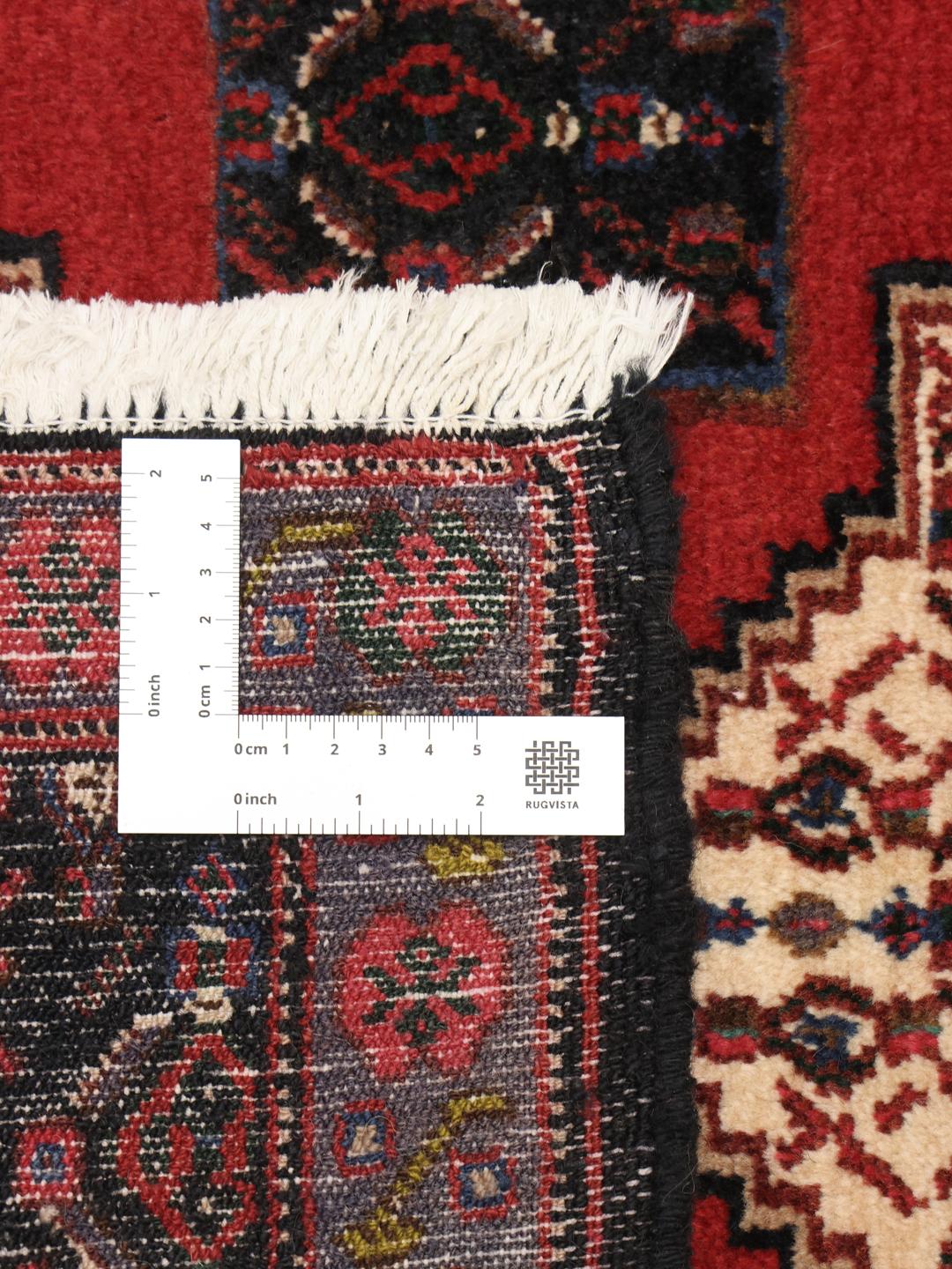 Hand-knotted Senneh rug from the Middle East in red and black