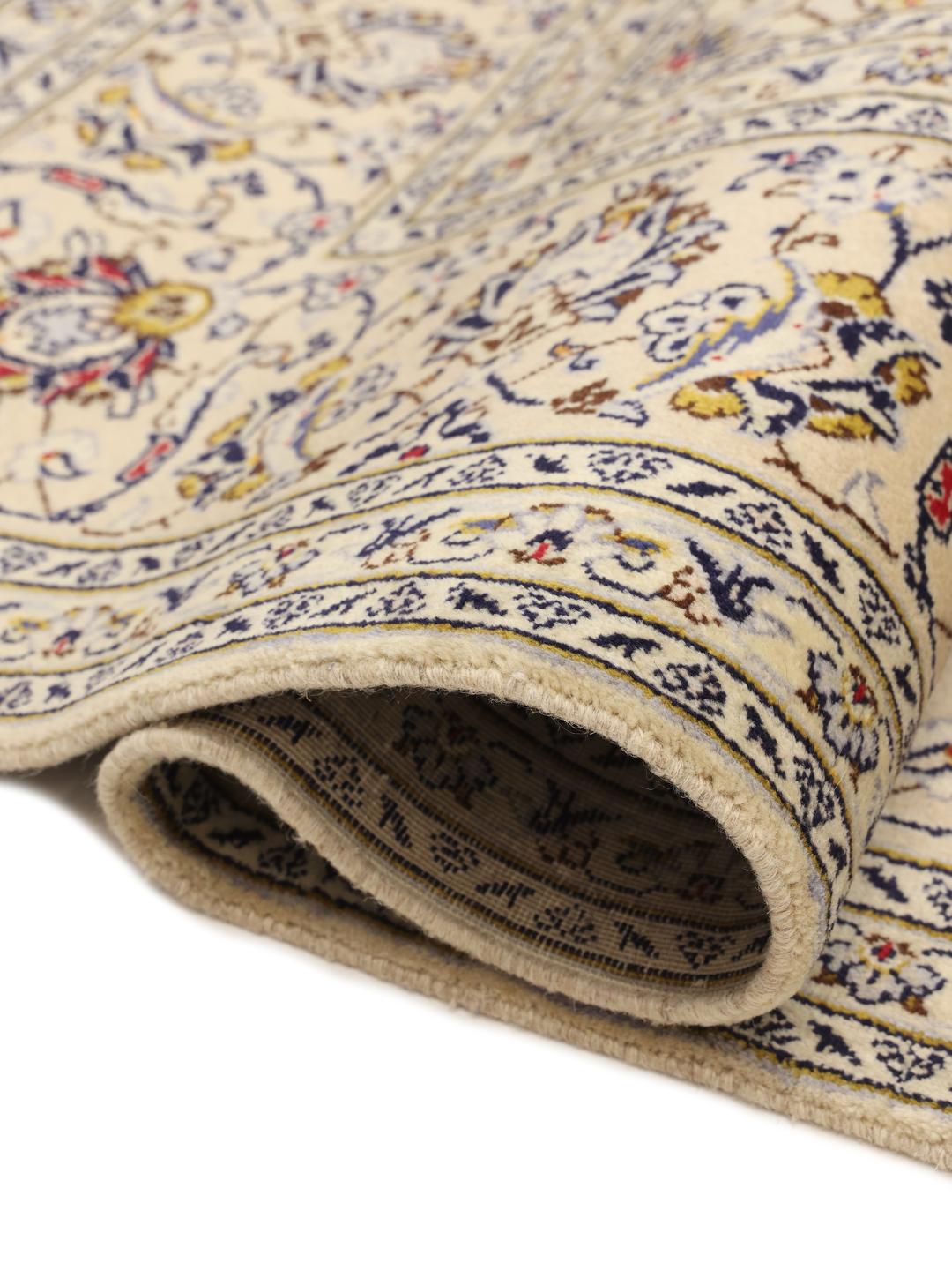 A large hand-knotted Keshan rug from the Middle East in beige with floral patterns.