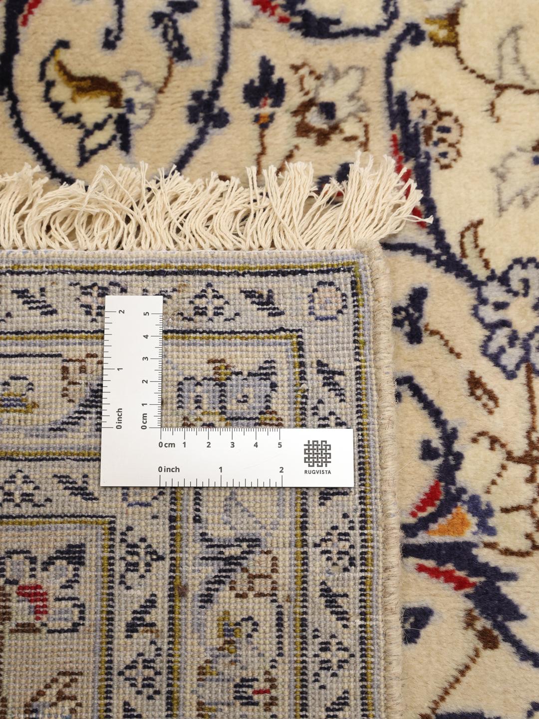 A large hand-knotted Keshan rug from the Middle East in beige with floral patterns.