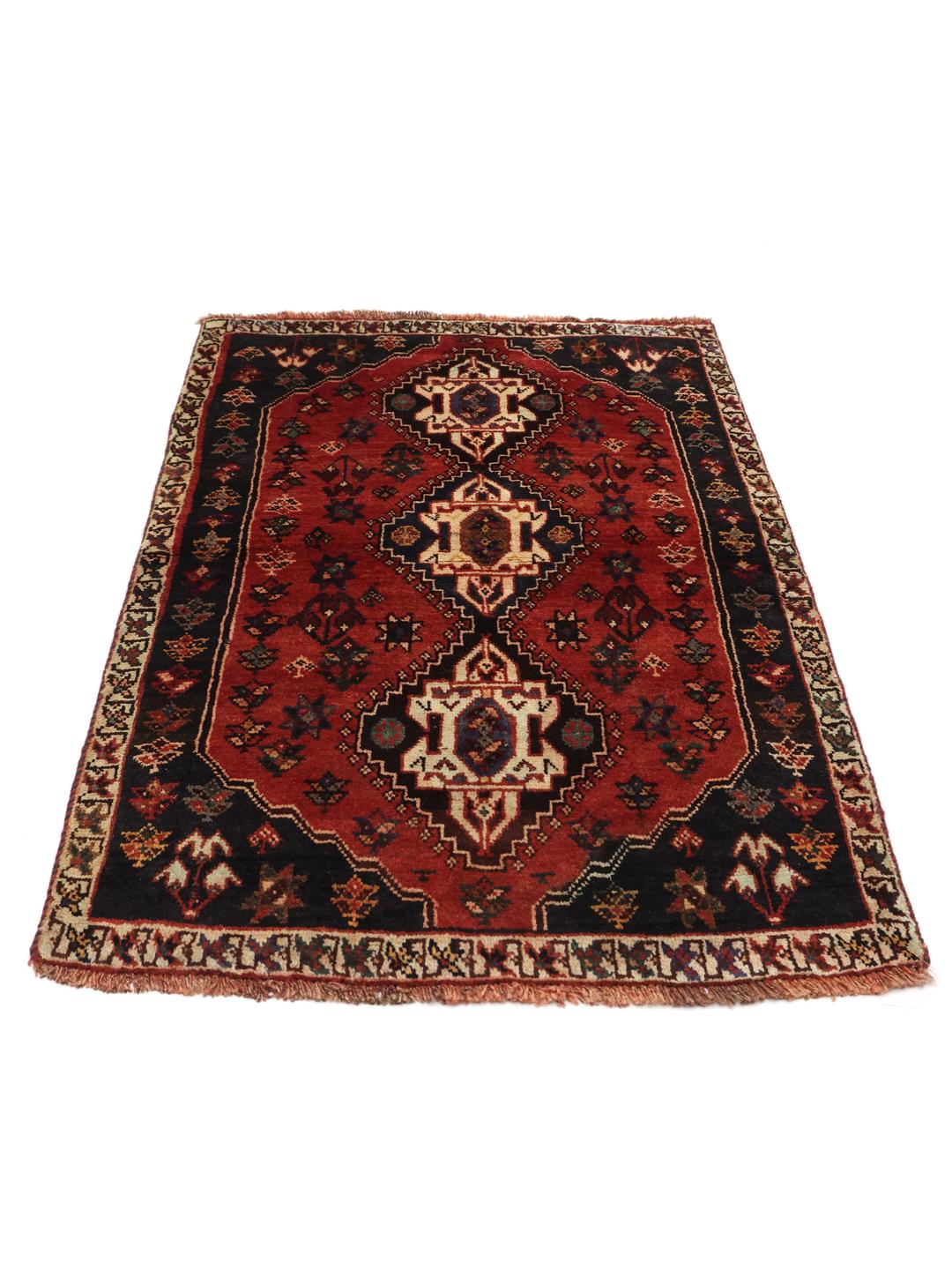 Hand-knotted Ghashghai rug from the Middle East featuring a red and dark blue geometric design