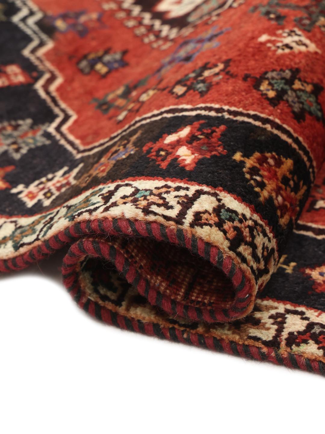 Hand-knotted Ghashghai rug from the Middle East featuring a red and dark blue geometric design