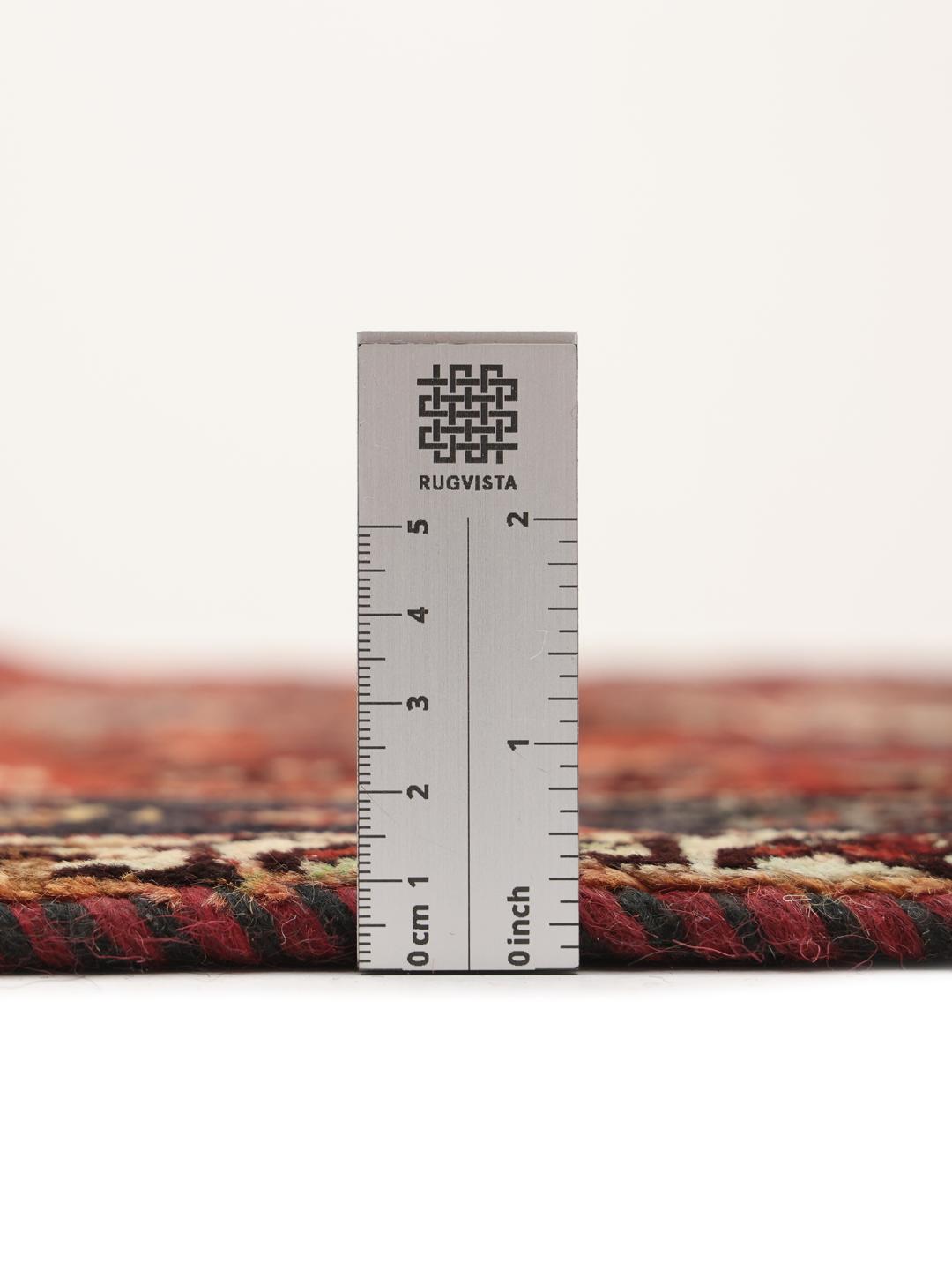 Hand-knotted Ghashghai rug from the Middle East featuring a red and dark blue geometric design