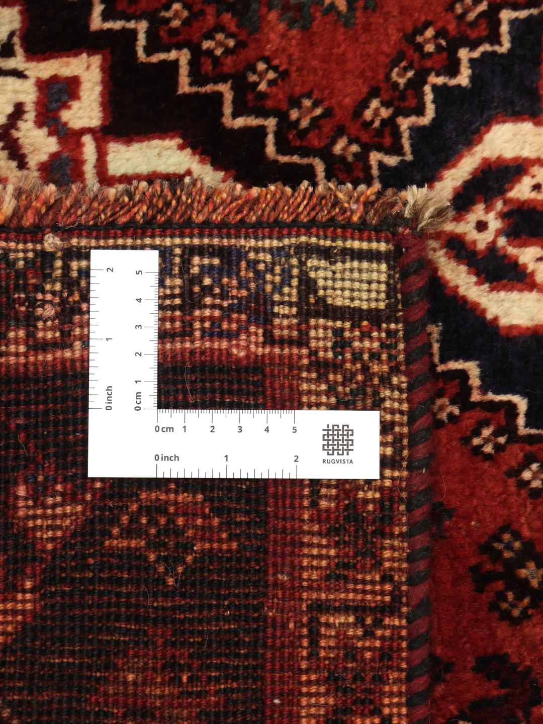 Hand-knotted Ghashghai rug from the Middle East featuring a red and dark blue geometric design